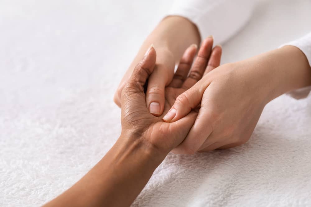 Closeup of acupuncture hand massage for black woman at spa salon, copy space