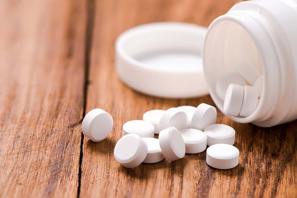 round pills on wood table,medicine